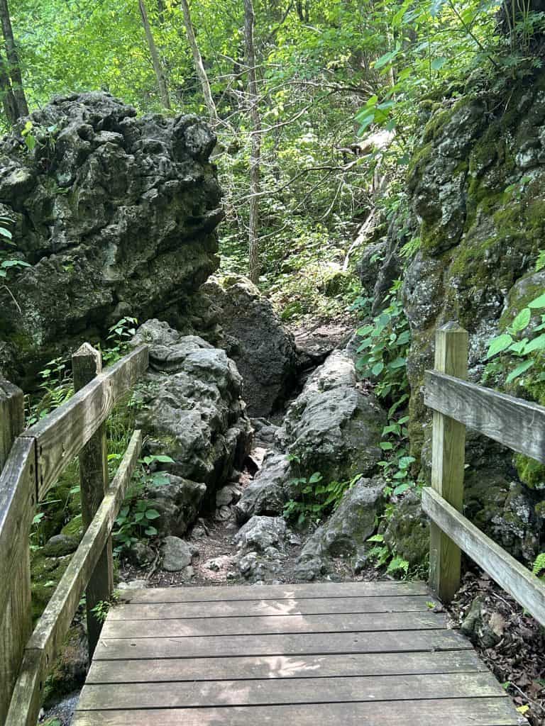 end of the boardwalk that leads to a tight path through large boulders/rocks
