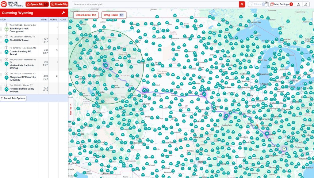 Trip planning map showing an RV route from Cumming, Georgia to Moran, Wyoming, with stops at campgrounds in Tennessee, Missouri, Nebraska, and Cheyenne, Wyoming. The map is covered with icons marking campgrounds, and a purple line traces the planned travel path across multiple states.