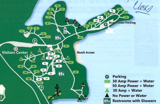 Illustrated campground map of Sawnee Campground on Lake Lanier showing numbered campsites, parking areas, restroom locations, and beach access. Campsites are color-coded for different utilities including 30 or 50 amp power and water, and some are marked as closed. The map highlights the Visitors Center, boat trailer parking, and restrooms with showers throughout the grounds.
