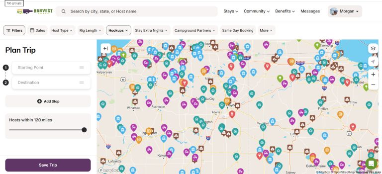Screenshot of the Harvest Hosts trip planning dashboard, showing a detailed map filled with colorful icons representing different host locations across Indiana and Ohio. The interface includes fields for starting point, destination, and host search radius, helping members plan RV trips with nearby Harvest Hosts stays.